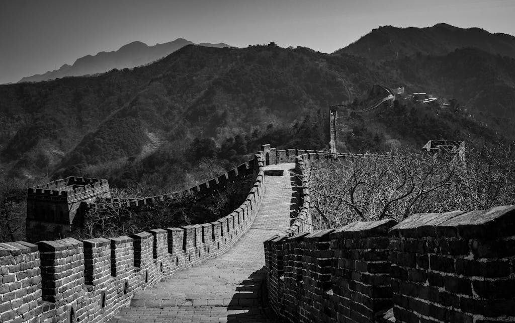 Stunning black and white capture of the Great Wall of China winding through mountainous landscape.